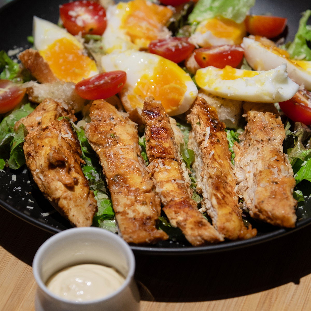 Protein-packed Caesar salad with grilled chicken breast and eggs at MESTO