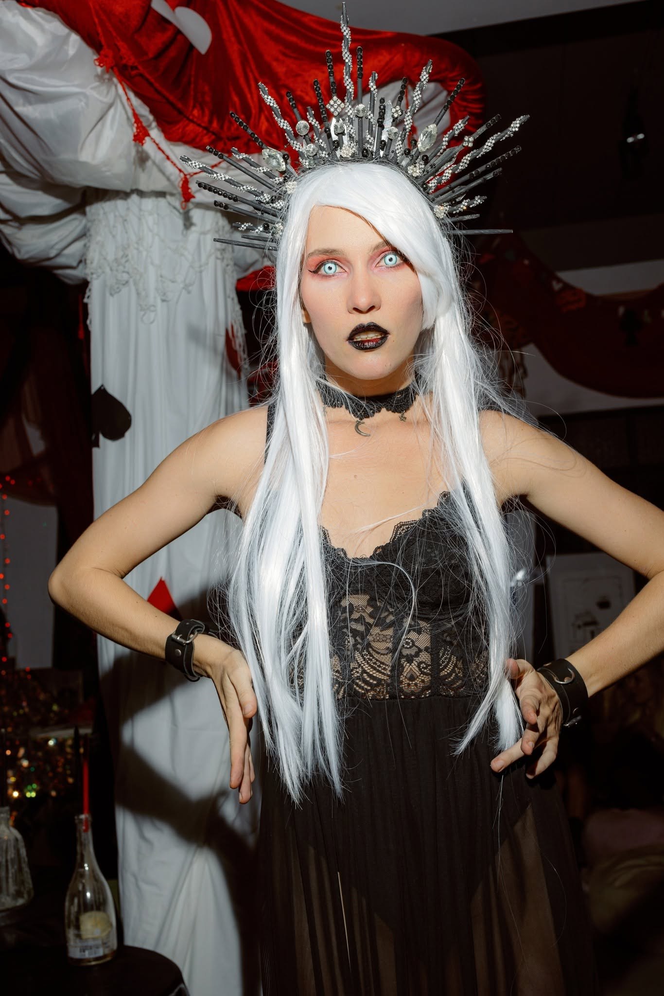 A guest with a white wig, a silver spiked crown and a black lace costume